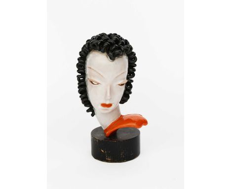 A Goldscheider Pottery bust, model no. 6427, modelled as a stylised woman with black curly hair, glazed in colours, mounted o