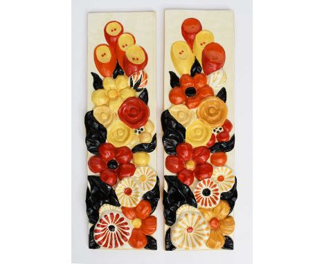 A pair of Clarice Cliff Bizarre wall plaques, rectangular, cast in relief with flowers and foliage, in shades of black, red, 