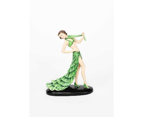 A Goldscheider Pottery model of a lady in a green costume by Stephan Dakon, model no. 8302, modelled walking in long ruffled 