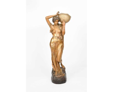 An Art Nouveau Goldscheider Pottery figural lamp by F Gross, model no.2770, modelled standing holding an Austrian iridescent 