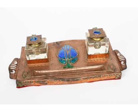 A large copper and enamel twin inkwell, rectangular, stamped in low relief with large central Art Nouveau flower bud motif en