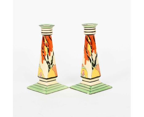'Honolulu' a pair of Clarice Cliff Bizarre candlesticks, painted in colours between green and black bands, printed factory ma