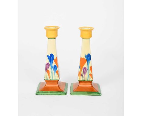 'Crocus' a pair of Clarice Cliff Octagonal candlesticks, painted in colours between yellow, brown and green bands, printed fa