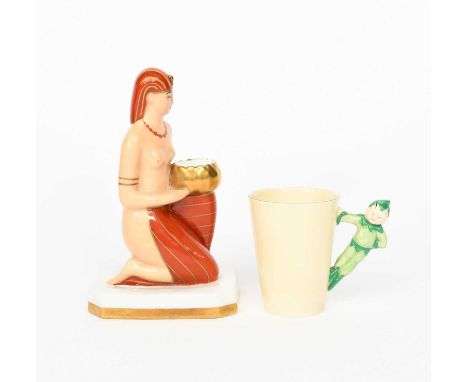 A Robj Paris Pottery brule parfums, modelled as a kneeling Egyptian, glazed in colours with gilt highlights, and a Clarice Cl