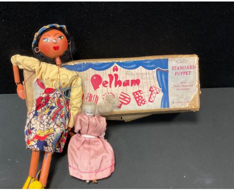 A Pelham puppet, Mexican Girl, Type SS, boxed;  an early 20th century porcelain doll's house doll, 16cm high 