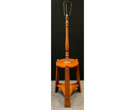 An Arts and Crafts oak table standard-lamp, turned lamp column to top, circular tripod table base, 147cm tall x 41cm diameter