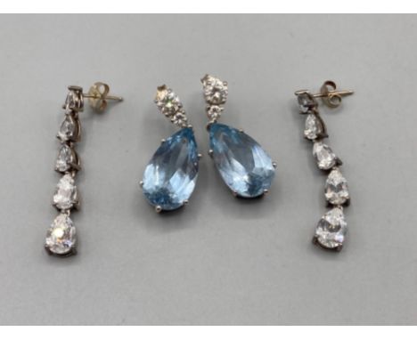 Two pairs of silver and CZ earrings, one with blue stones