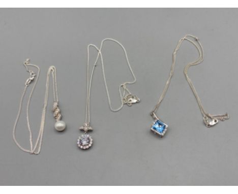 Three silver pendants with pearl CZ and blue stone on silver chains 13g gross