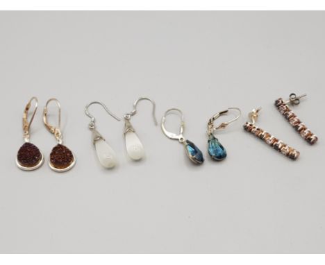 Four pairs of silver earrings of various designs