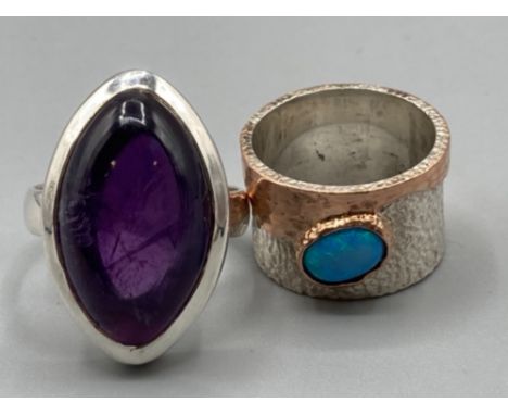 Two silver rings one with purple stone size R 10.6g gross and opal stone size M 7.5g gross