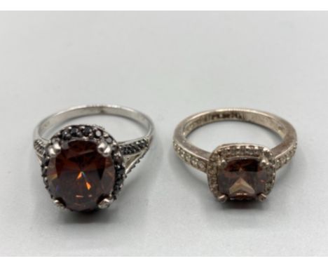 Two silver and CZ rings with brown stones sizes U and P 9.8g gross