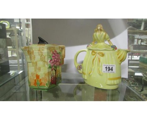 A sundial teapot reg no. 826924 and a crinoline lady teapot