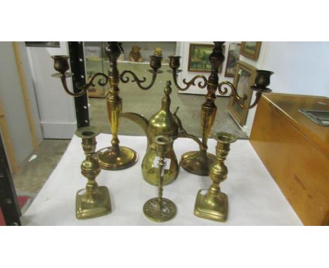 A mixed lot of brassware comprising 2 pairs of candlesticks, a single candlestick and an Arabian style coffee pot