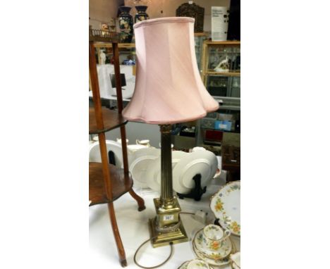 A brass Corinthian column table lamp with shade