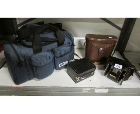 A Kodak portrait brownie camera, a Petriflex camera with instruction book, a quantity of lenses, other camera accessories, a 