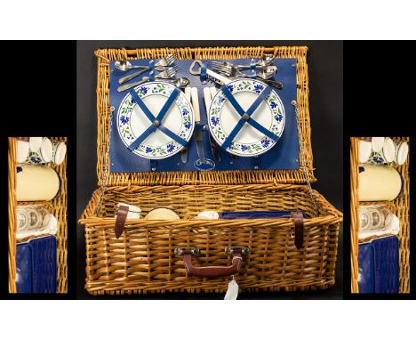 A Wicker Picnic Hamper with four place settings. Fully fitted with flask, plates, cups, cutlery, sandwich boxes etc. Plaque t