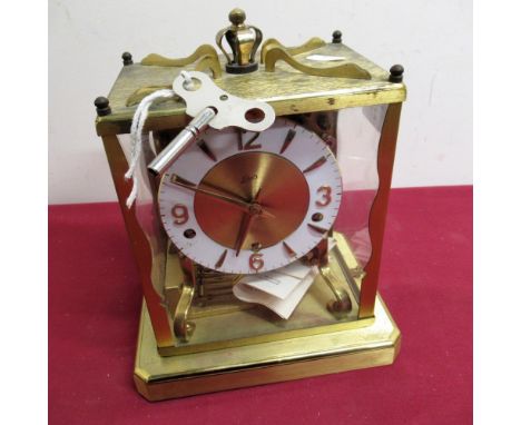 Mid 20th C Schatz mantel clock, lacquered brass case  with four glazed panels on platform base, three train triple chiming St