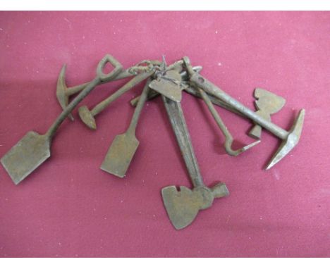 Collection of metal miniature or sample hand tools comprising two shovels, two pick axes, three axes, sledgehammer and hoe L1