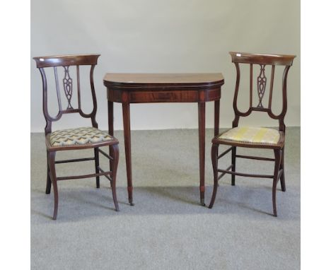 A George III mahogany D shaped folding card table, 71cm, together with a pair of Edwardian side chairs. 