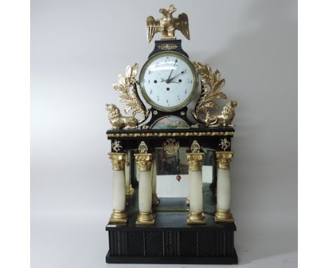 A 19th century painted wooden mantle clock, of architectural form with a musical box in base, the enamel dial with subsidiary