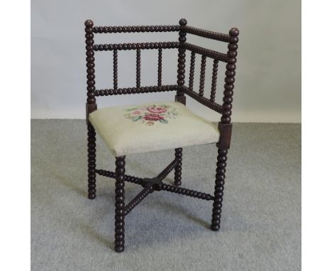 A 19th century bobbin turned corner chair, with a tapestry seat