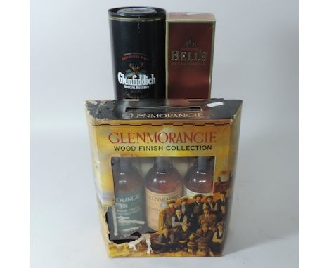 A box of three Glenmorangie Woodfinish collection malt whiskies, together with a Glenfiddich special reserve scotch and a Bel