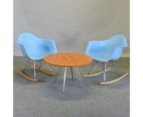 A pair of moulded blue plastic rocking chairs, together with an orange plastic button coffee table