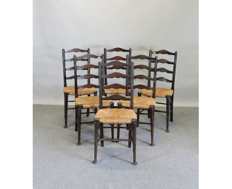 A set of six rush seated ladder back dining chairs 