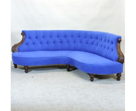 A Victorian blue upholstered corner sofa, with scrolled carved mahogany arms, on turned legs, 210cm