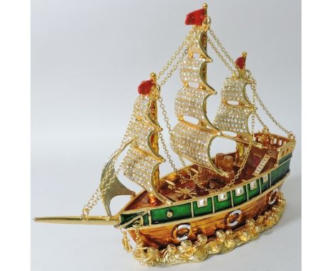 A coloured glass and enamel box, in the form of a ship, 23cm tall, boxed