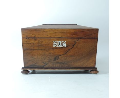 A late Regency rosewood and mother of pearl inlaid tea caddy, of sarcophagus form, with a fitted interior, 32cm 
