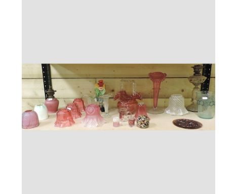 A shelf of Victorian and later coloured glass, to include a Murano clown, 24cm tall, a frilled glass basket and cranberry gla