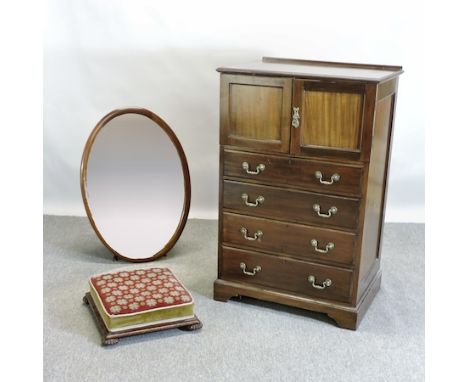 An early 20th century mahogany tallboy, 69cm, together with an oval wall mirror and a Victorian tapestry footstool, on fluted
