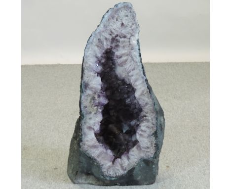 A raw amethyst stone, 62cm tall