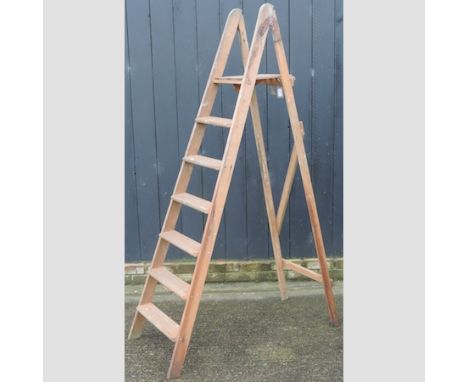 A wooden folding step ladder