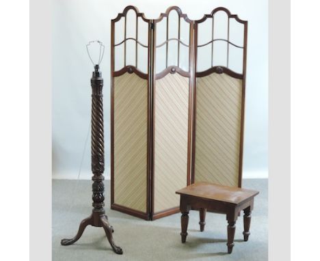 An Edwardian walnut and fabric covered and glazed three fold dressing screen, 137cm, together with a carved mahogany standard