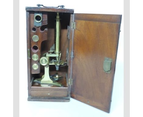 A 19th century brass microscope, in a fitted mahogany case, 39cm tall