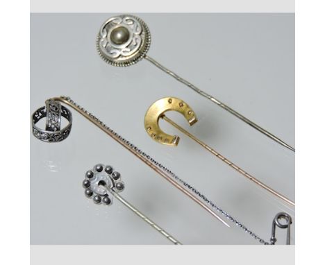 A collection of yellow metal stick pins