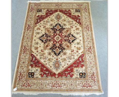 A Heriz carpet, with a central medallion, on a beige ground, 280 x 200cm