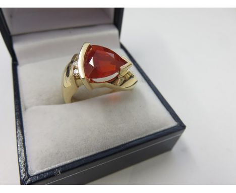 FIRE OPAL RING, heavy 14ct yellow gold ring, set a large triangular form fire opal with diamonds to shoulder, size P/Q