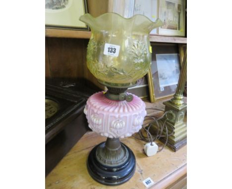 VICTORIAN OIL LAMP, a Victorian oil lamp with red opaque glass reservoir, yellow shade on turned support, 22"