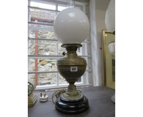 OIL LAMP, Edwardian embossed brass base oil lamp with milk glass spherical shade