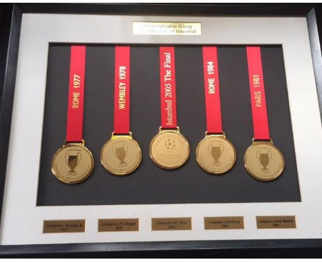 Liverpool FC Football Display. Mounted display of 5 replica European Cup and Champions League winners medals. 1977, 1978, 198