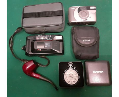 A Ricoh FF-90 camera and case, a Kodak Advantix F350 camera and case, a Falcon Coolway pipe and a Sekonda stopwatch. Location