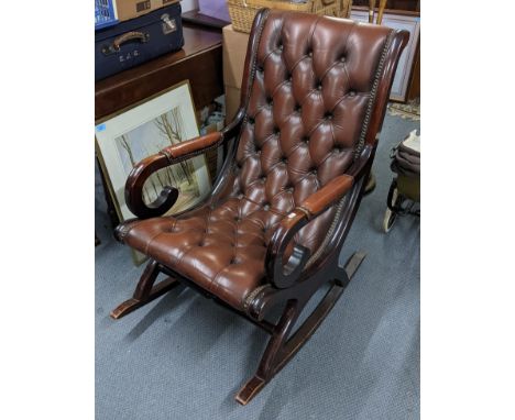 A reproduction mahogany button back slipper rocking chair Location: 