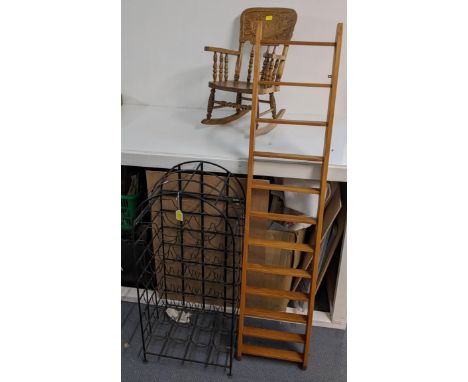 A mixed lot to include a wrought metal wine rack, an oak ladder, a small rocking chair, and a Necchi sewing machine Location: