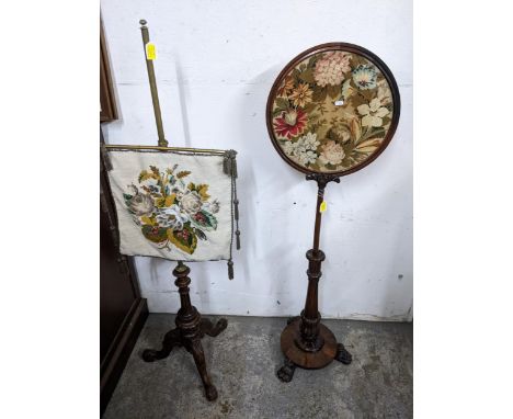 A Regency rosewood pole screen with circular tapestry and an early Victorian carved mahogany and brass adjustable fire screen