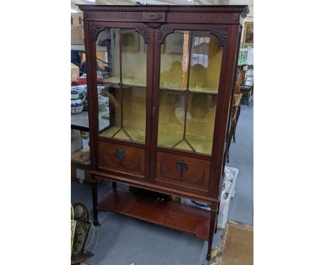 An Edwardian mahogany display bookcase having a dental moulded cornice, two glazed doors, and open shelf below 175.5cm h x 10