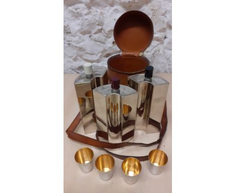 An early 20th Century travel set of 3 tin lined flasks and 4 gilt interior beakers within a hide leather carrying case, made 