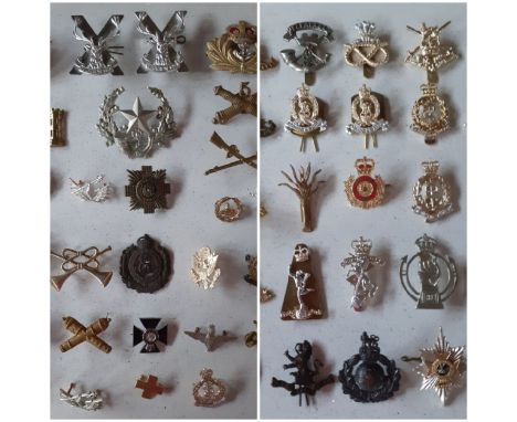 A collection of military cap badges to include The Somerset Light Infantry (Prince Albert's Own) cap badge, various Gaunt rep